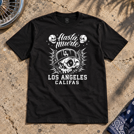 Hasta La Muerte T Shirt Black flat lay creative with a meaningful themed background
